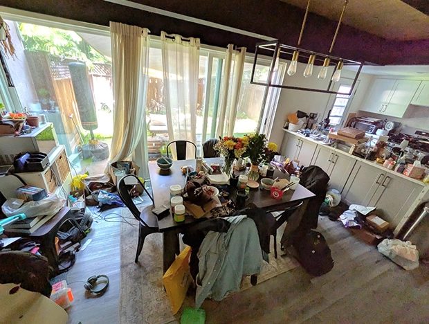 Messy dining room and kitchen with clutter everywhere