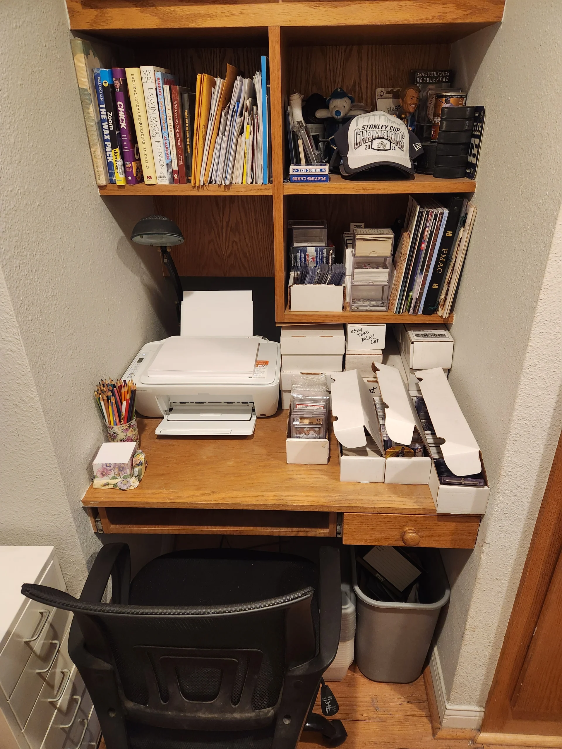 Home office nook with desk, printer, books and organized shelves
