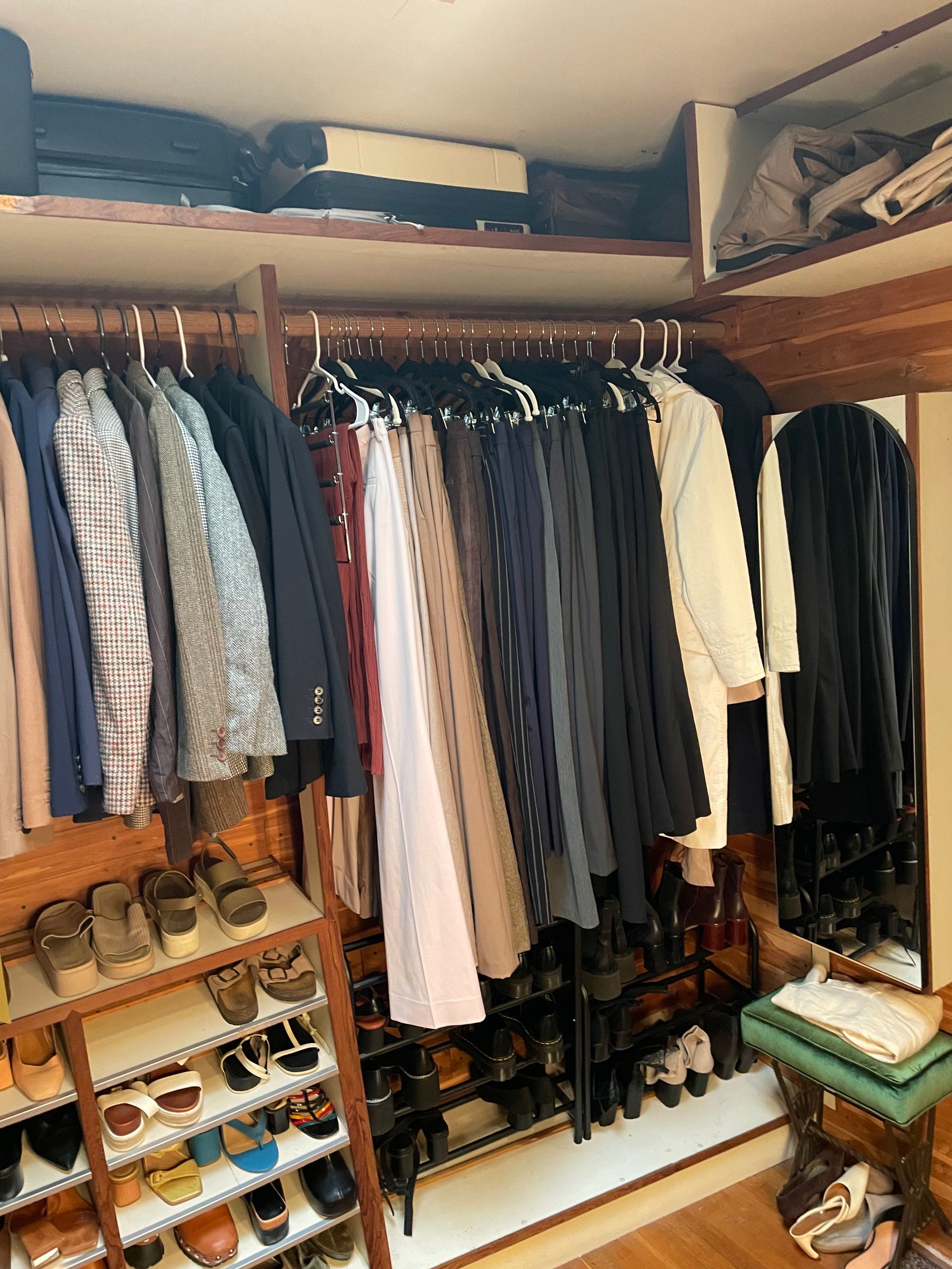 Organized closet with suits, shoes, and hanging storage