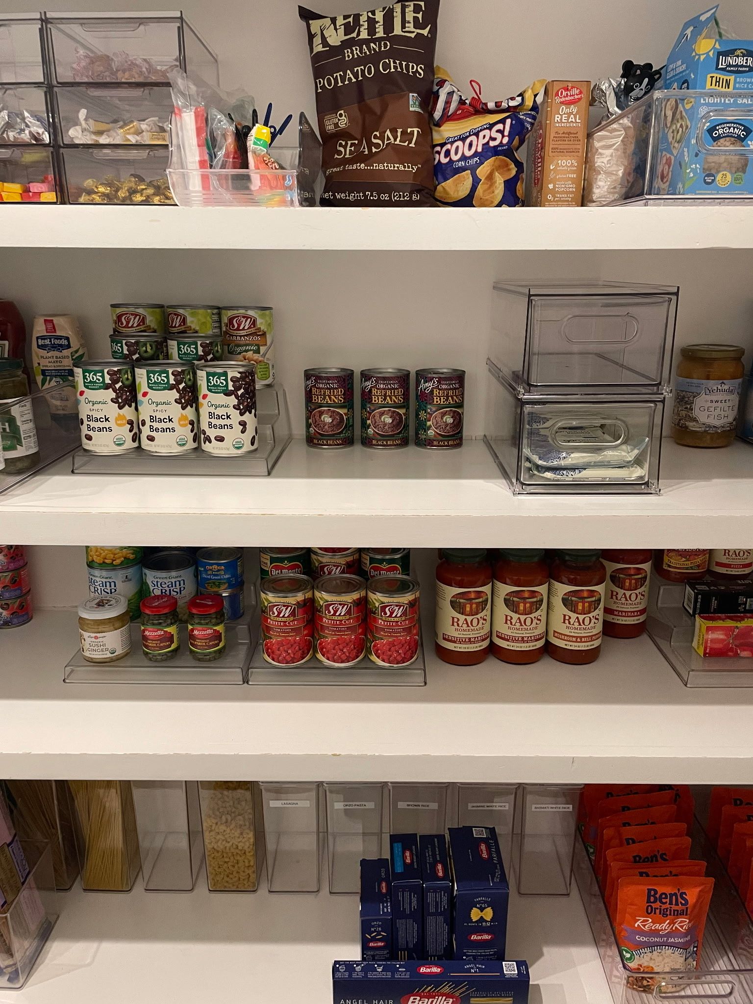 Pantry shelves with neatly arranged canned goods and snacks